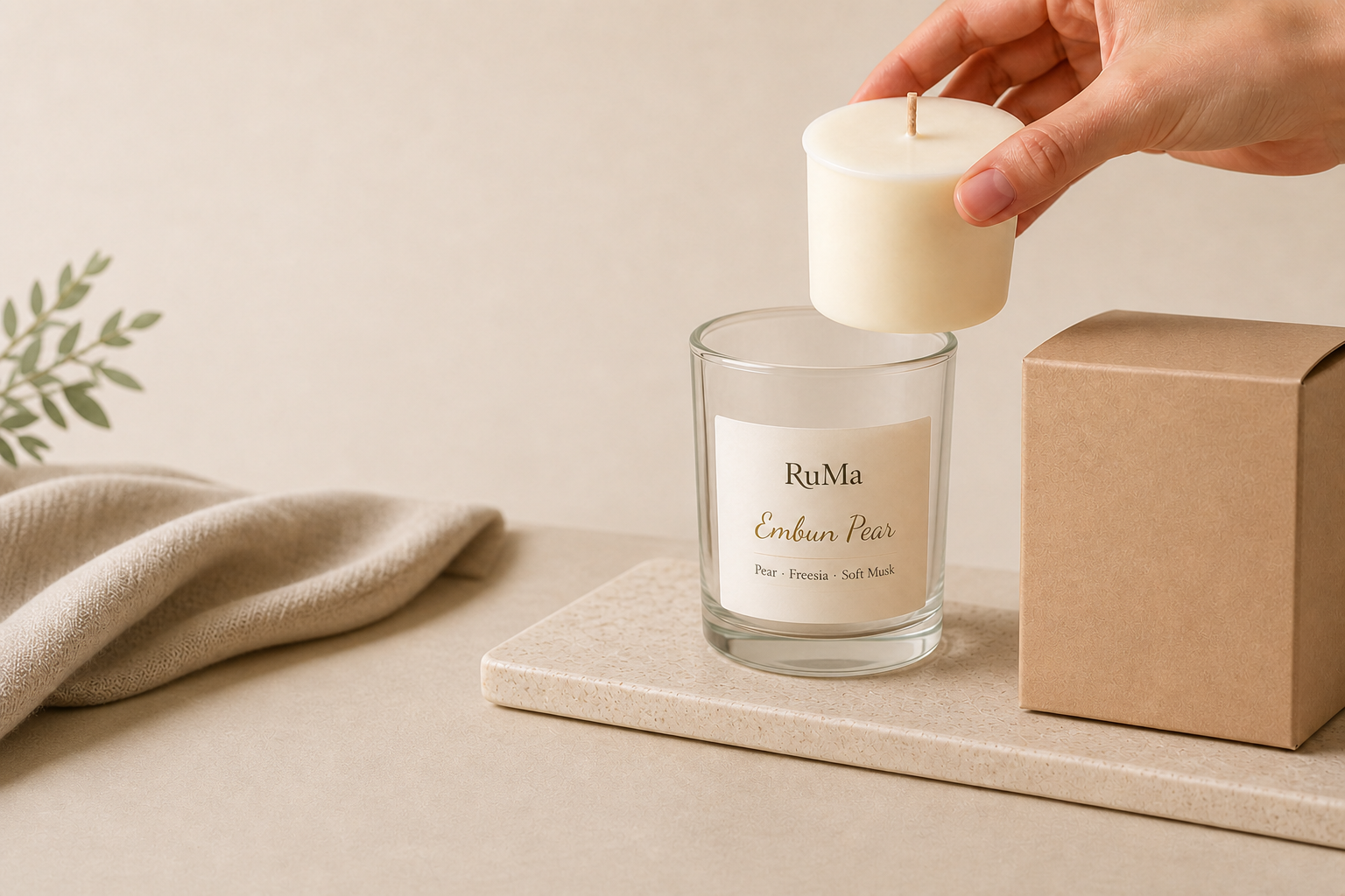 RuMa candle refill being placed into a reusable glass jar